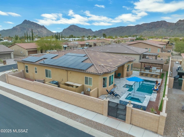 view of front of property featuring a residential view, a fenced backyard, an outdoor hangout area, a patio, and stucco siding