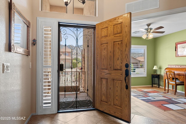 entrance foyer with visible vents, baseboards, and a ceiling fan