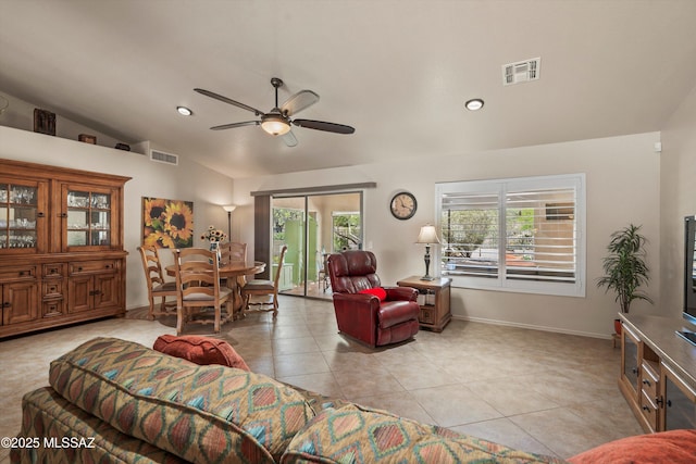 living area featuring visible vents, vaulted ceiling, a ceiling fan, and light tile patterned flooring