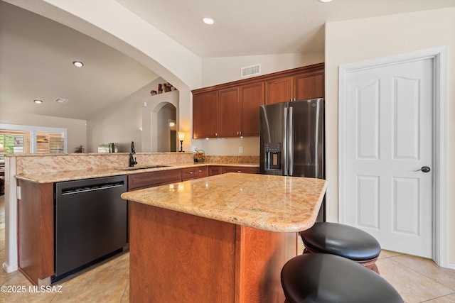 kitchen featuring arched walkways, stainless steel refrigerator with ice dispenser, dishwasher, a sink, and lofted ceiling