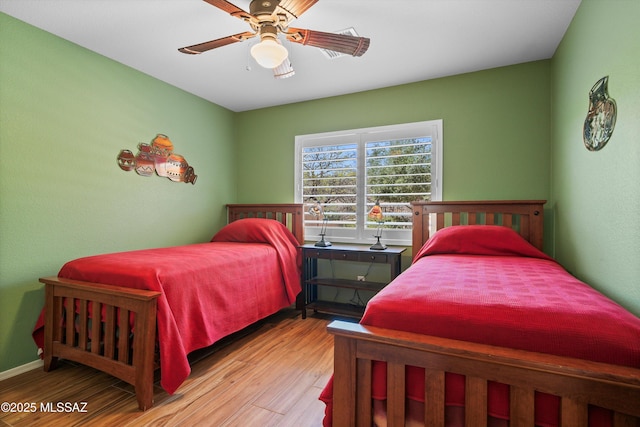 bedroom with a ceiling fan and wood finished floors
