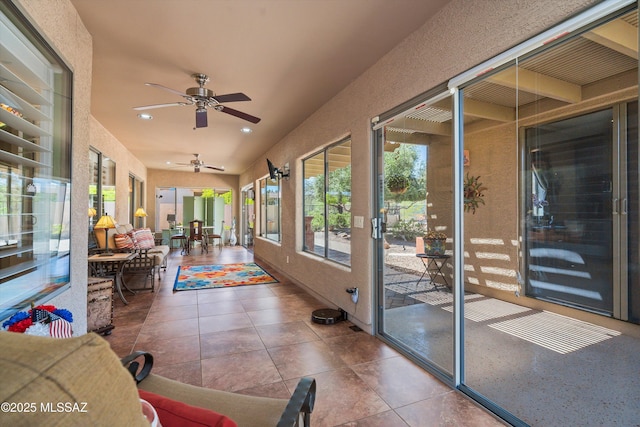 sunroom featuring ceiling fan, tile patterned flooring, and recessed lighting