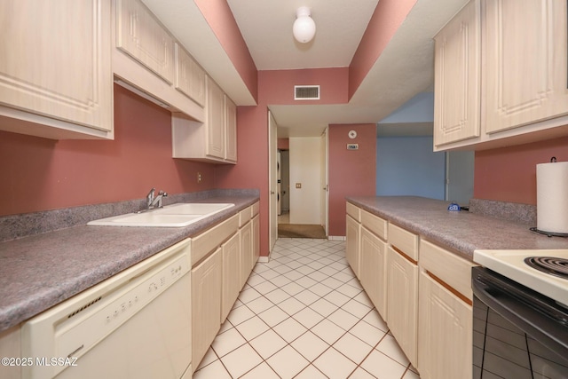 kitchen with dishwasher, visible vents, a sink, and light tile patterned flooring