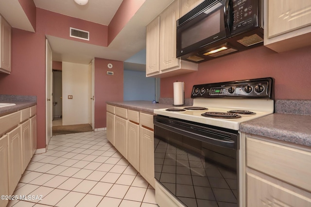 kitchen with black microwave, electric range, light tile patterned floors, and visible vents