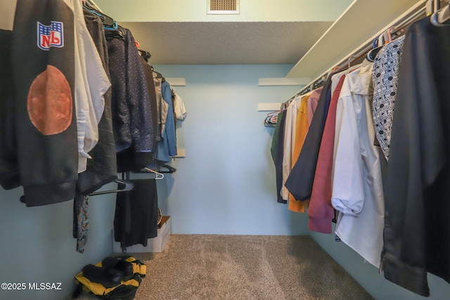 spacious closet featuring visible vents and carpet
