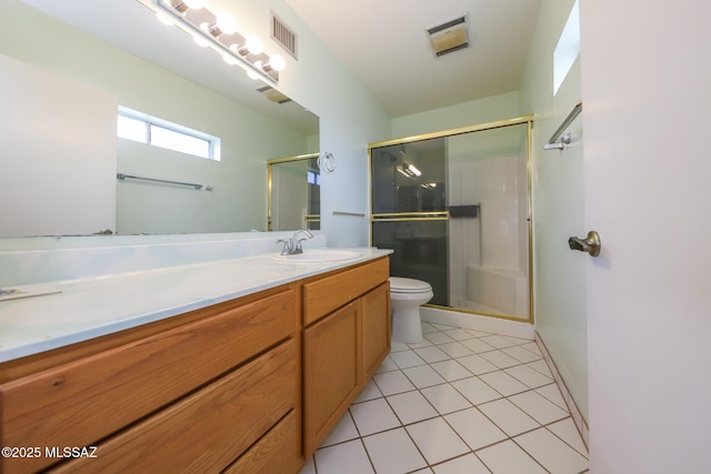 bathroom featuring toilet, vanity, visible vents, and a stall shower