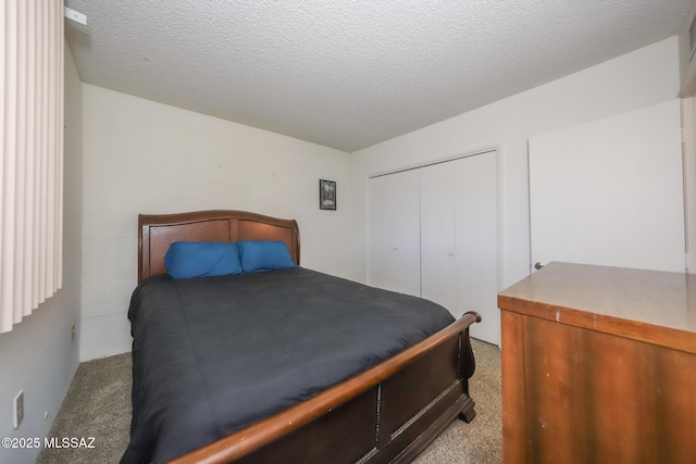 bedroom with a closet, a textured ceiling, and carpet