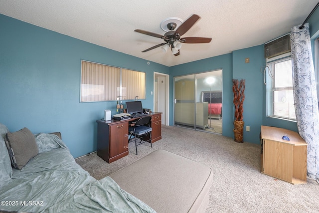 office featuring carpet floors, a ceiling fan, and a textured ceiling