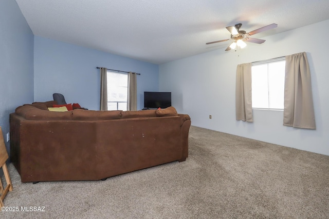 carpeted living room with a ceiling fan