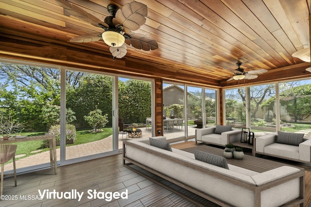 sunroom featuring a wealth of natural light, an outdoor living space, outdoor dining area, and ceiling fan