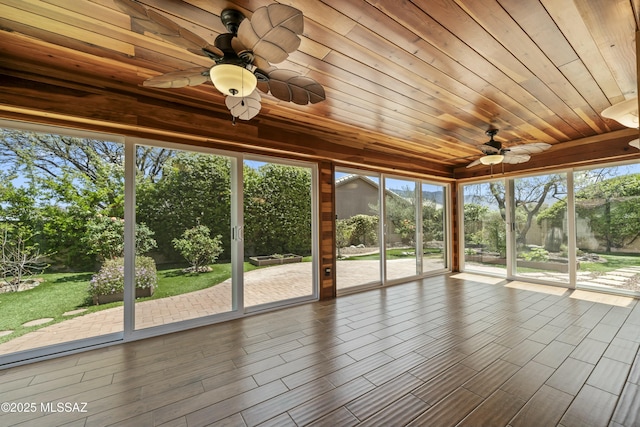 unfurnished sunroom with a ceiling fan