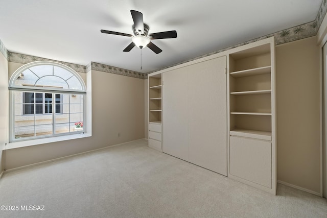 unfurnished bedroom with carpet flooring, baseboards, and a ceiling fan