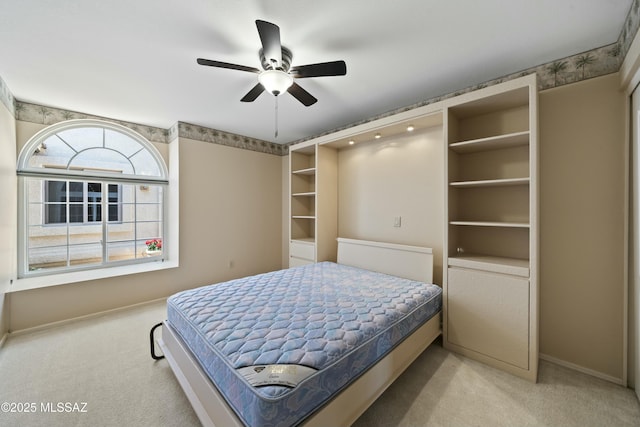 bedroom featuring baseboards, ceiling fan, and light colored carpet