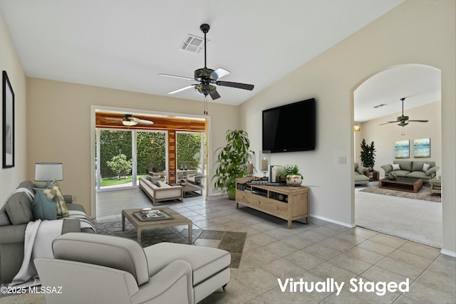 living room with light tile patterned flooring, ceiling fan, and lofted ceiling