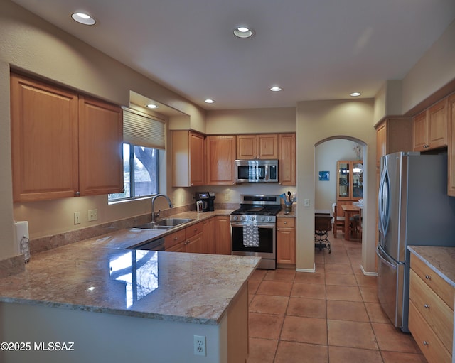 5200 E Calle Vista De Colores, Tucson, AZ 85711 - kitchen with stainless steel appliances, a sink, arched walkways, recessed lighting, and light stone countertops
