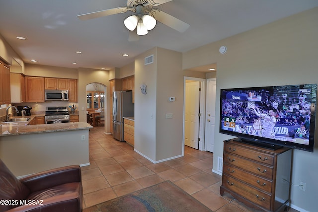5200 E Calle Vista De Colores, Tucson, AZ 85711 - kitchen with stainless steel appliances, a sink, light tile patterned floors, ceiling fan, and recessed lighting