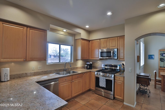 5200 E Calle Vista De Colores, Tucson, AZ 85711 - kitchen featuring appliances with stainless steel finishes, a sink, arched walkways, recessed lighting, and light tile patterned floors