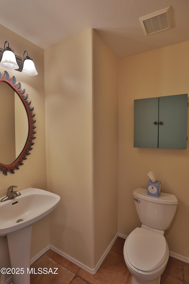 5200 E Calle Vista De Colores, Tucson, AZ 85711 - half bath with toilet, tile patterned floors, a sink, and baseboards