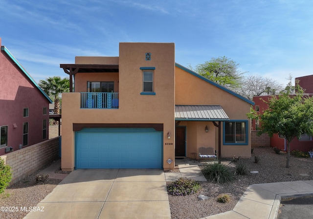 5200 E Calle Vista De Colores, Tucson, AZ 85711 - view of front of home featuring a garage, a standing seam roof, concrete driveway, stucco siding, and metal roof