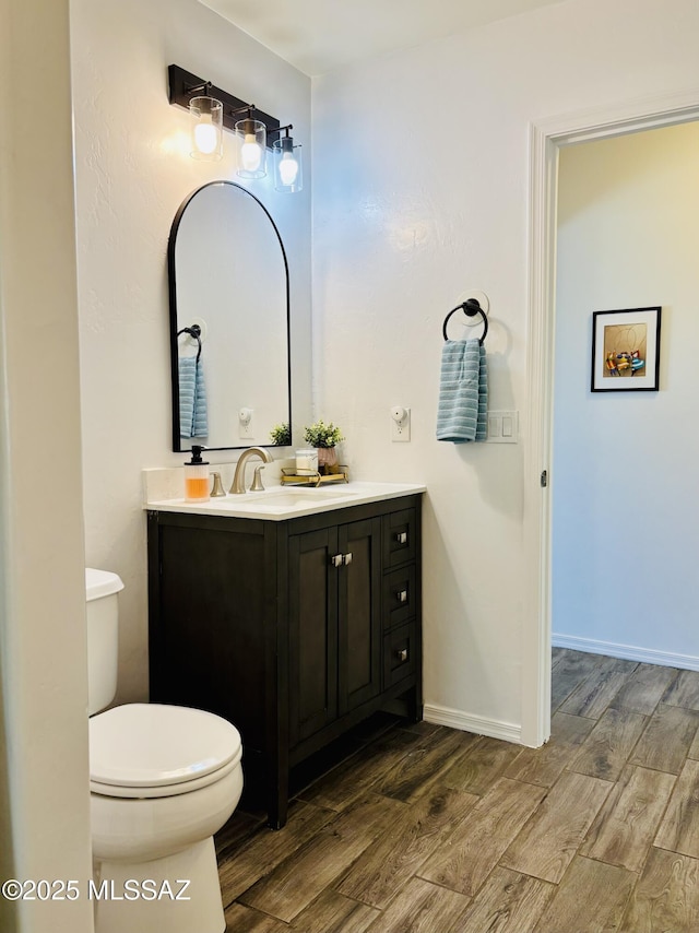 8332 S Otis Dr, Tucson, AZ 85747 - full bathroom with toilet, baseboards, vanity, and wood finished floors