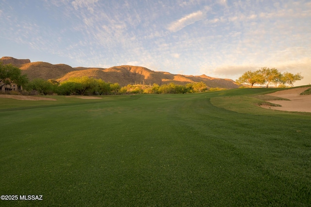 surrounding community featuring a lawn, a mountain view, and golf course view