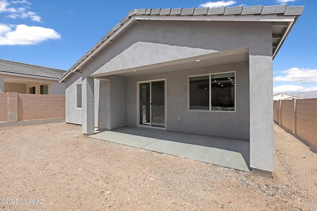 back of house featuring a patio area, stucco siding, and a fenced backyard