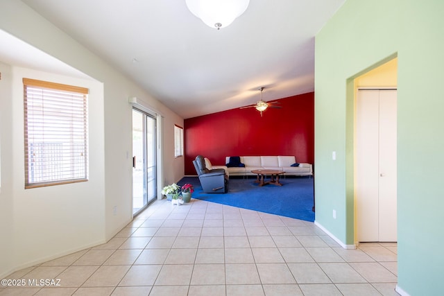 10532 E Malta St, Tucson, AZ 85747 - living room featuring a ceiling fan, light tile patterned flooring, light carpet, and baseboards