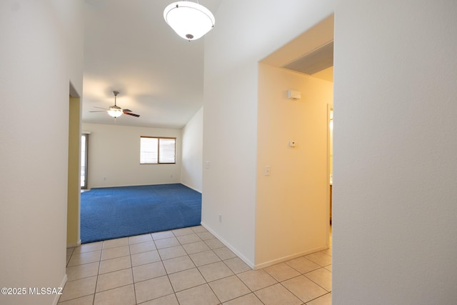 10532 E Malta St, Tucson, AZ 85747 - empty room featuring ceiling fan, light tile patterned floors, light colored carpet, and baseboards