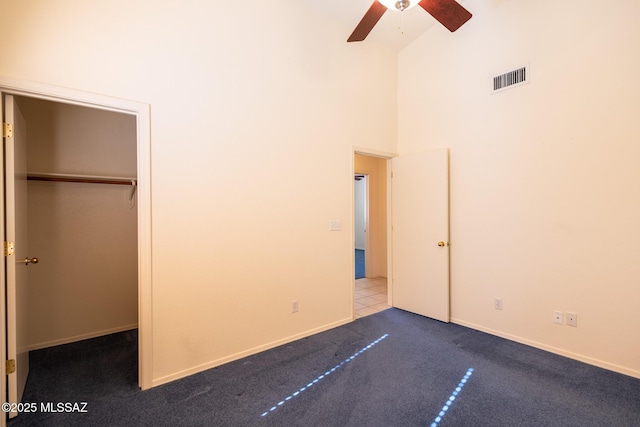 10532 E Malta St, Tucson, AZ 85747 - unfurnished bedroom with high vaulted ceiling, carpet flooring, a closet, a ceiling fan, and baseboards