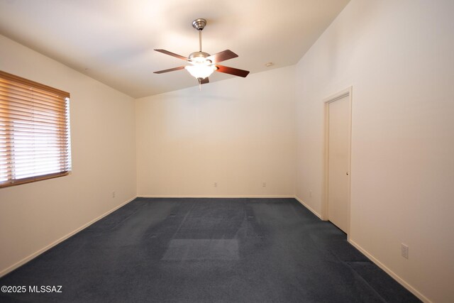 10532 E Malta St, Tucson, AZ 85747 - empty room featuring ceiling fan, dark colored carpet, baseboards, and vaulted ceiling