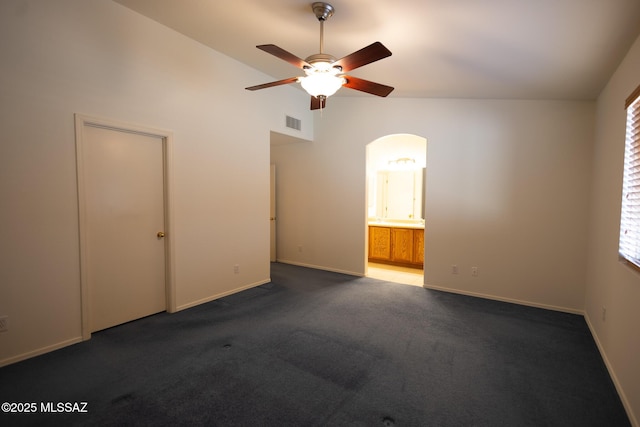 10532 E Malta St, Tucson, AZ 85747 - carpeted empty room featuring ceiling fan, arched walkways, vaulted ceiling, and baseboards