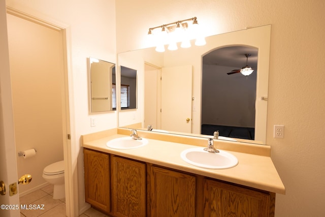 10532 E Malta St, Tucson, AZ 85747 - full bathroom featuring ceiling fan, toilet, double vanity, tile patterned flooring, and connected bathroom