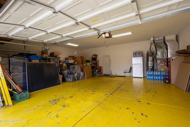10532 E Malta St, Tucson, AZ 85747 - garage with a garage door opener, freestanding refrigerator, gas water heater, and heating unit