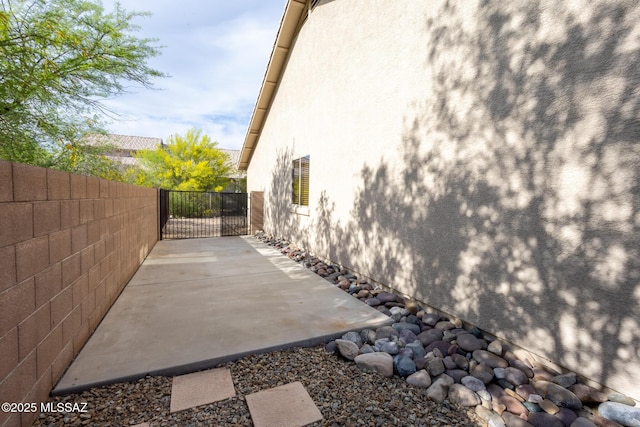 10532 E Malta St, Tucson, AZ 85747 - view of side of home with stucco siding, fence, and a patio area