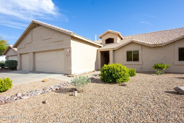 10532 E Malta St, Tucson, AZ 85747 - view of front of property featuring a garage, stucco siding, a tiled roof, and concrete driveway