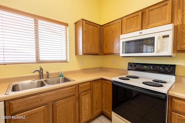 10532 E Malta St, Tucson, AZ 85747 - kitchen with range with electric stovetop, white microwave, a sink, and light countertops