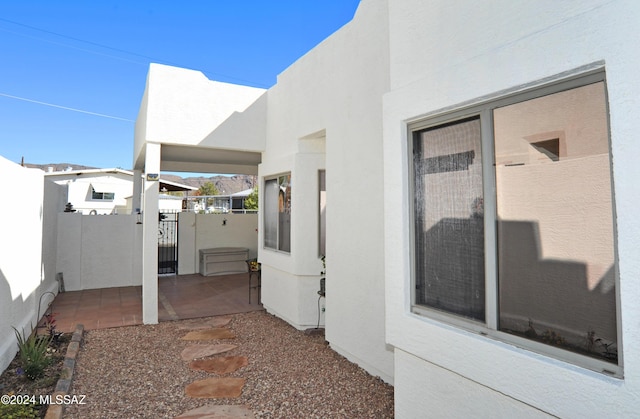 view of patio featuring fence and a gate