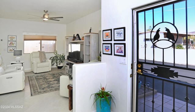 foyer with tile patterned flooring and a ceiling fan