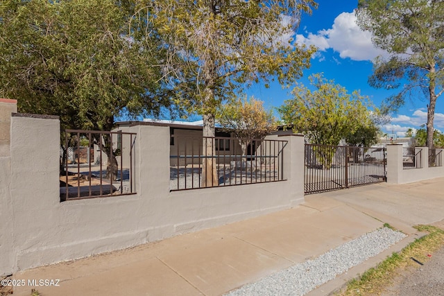 view of gate featuring a fenced front yard