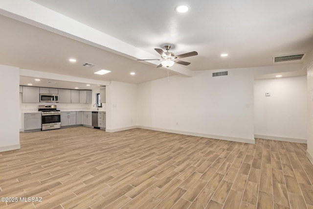 unfurnished living room with light wood finished floors and visible vents