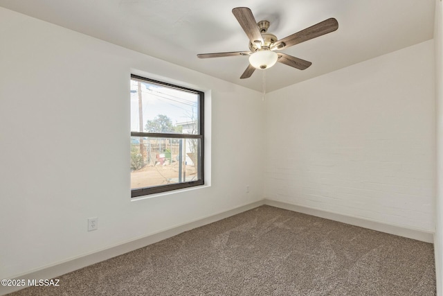 spare room featuring ceiling fan, baseboards, and carpet floors