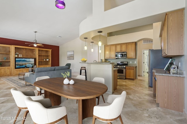 dining space featuring high vaulted ceiling and a ceiling fan