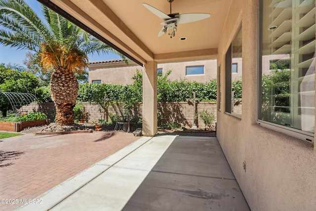 view of patio with a fenced backyard and ceiling fan