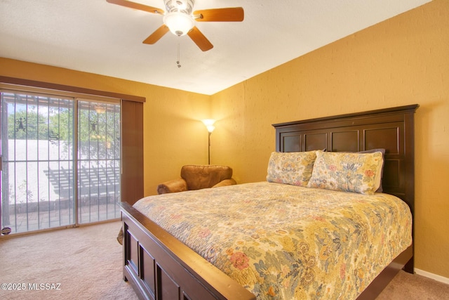 bedroom with light colored carpet, a textured wall, baseboards, access to exterior, and ceiling fan