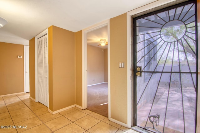 interior space featuring baseboards and light tile patterned floors