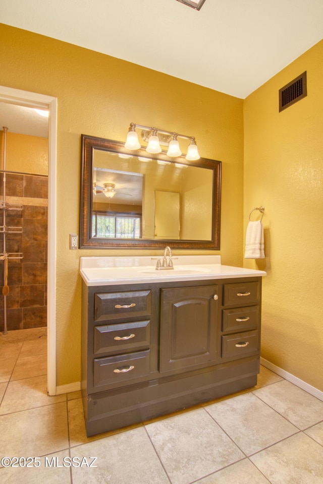 bathroom featuring baseboards, visible vents, tile patterned flooring, and vanity