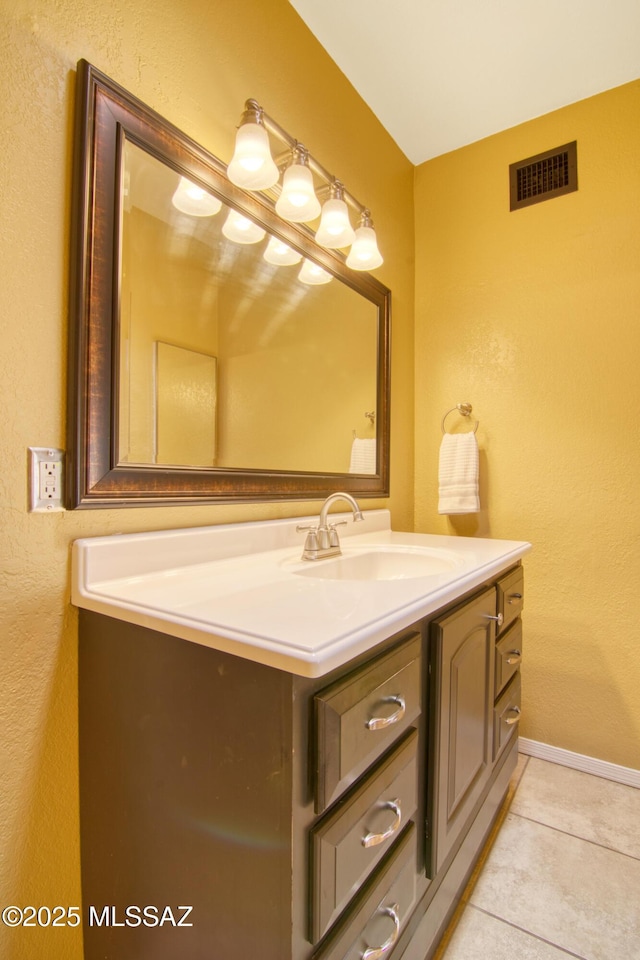 bathroom featuring tile patterned flooring, vanity, baseboards, and visible vents