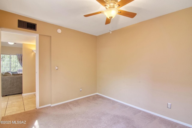 unfurnished room featuring a ceiling fan, light carpet, baseboards, and visible vents