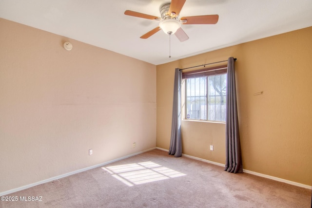 unfurnished room featuring carpet flooring, baseboards, and ceiling fan