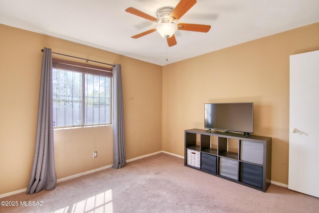 interior space with baseboards, carpet flooring, and ceiling fan